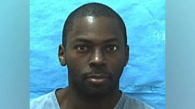 Mark Gordon police photograph - wearing prison uniform and closely cut hair