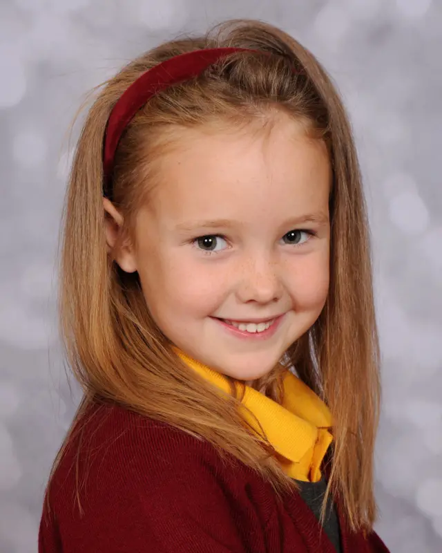 Elsie Dot Stancombe in her burgundy school uniform