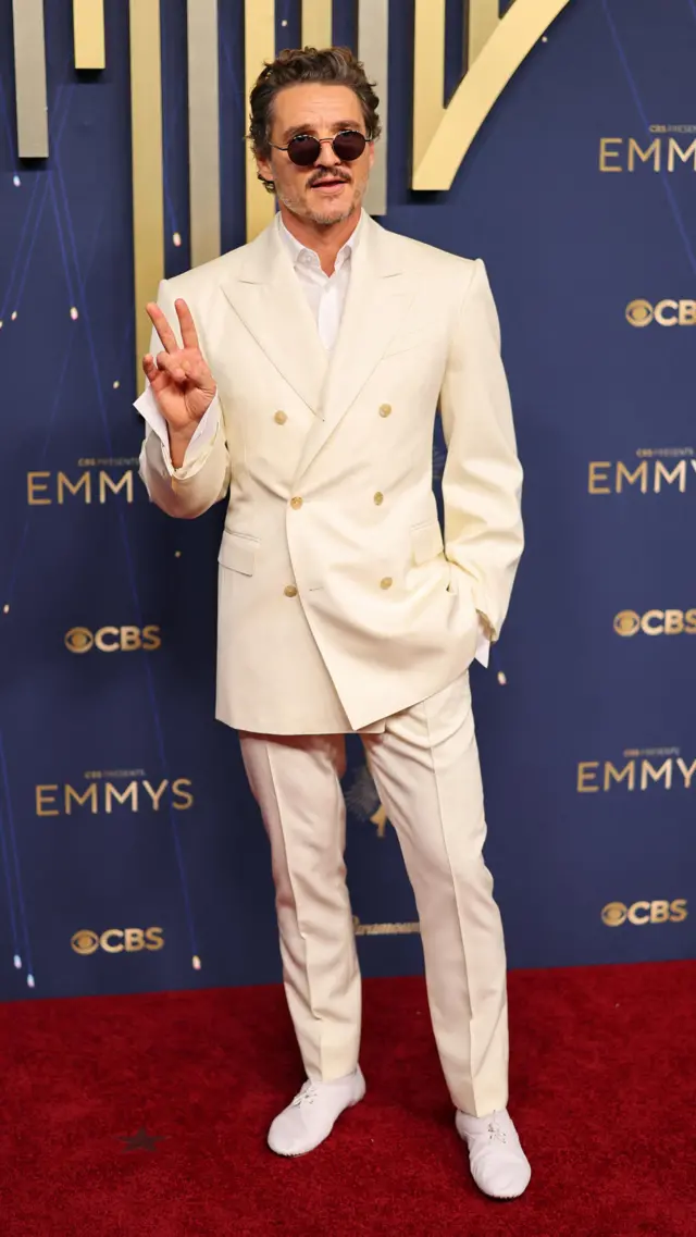 Pedro Pascal poses in a cream suit