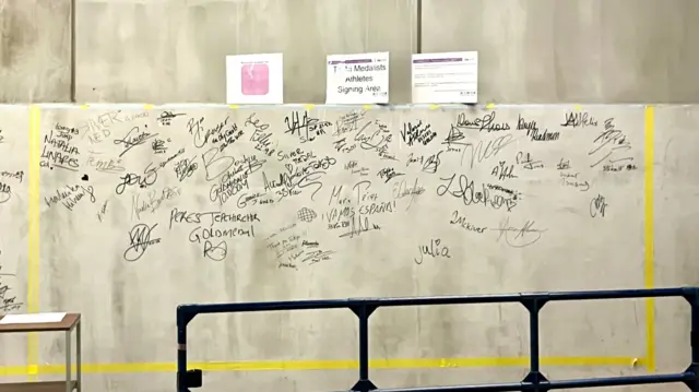A wall inside the stadium for medallists to sign
