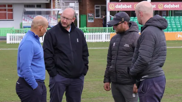 Umpiores and groundstaff confer at Leicester