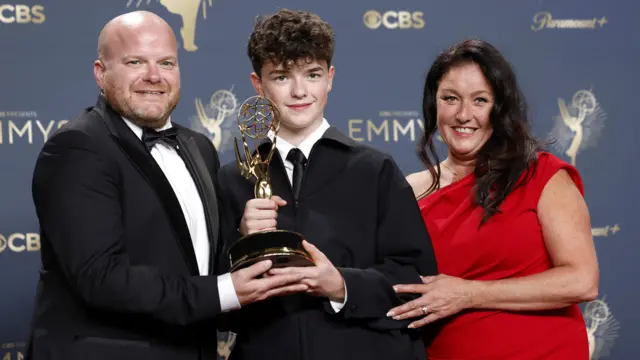 Owen Cooper stands with his parents