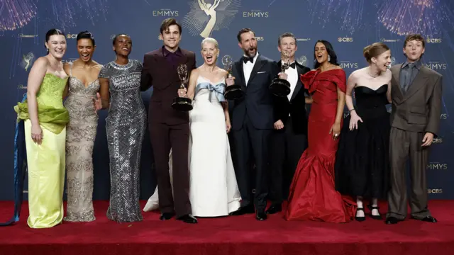 Noah Wyle (C-R), Best Actor in a Drama Series, Katherine LaNasa(C-L), Best Supporting Actress in a Drama Series, and team of 'The Pitt', which won Best Drama Series, pose at the 77th annual Emmy Awards ceremony held at the Peacock Theater in Los Angeles