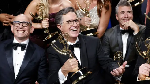 Stephen Colbert (2-L) and the team pose with the Best Talk Show award for 'The Late Show With Stephen Colbert', at the 77th annual Emmy Awards ceremony held at the Peacock Theater in Los Angeles, California