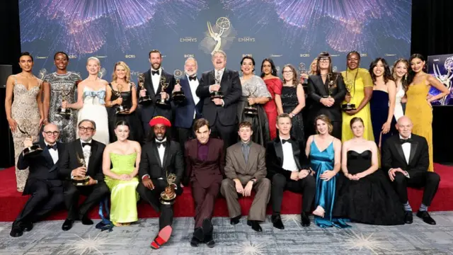 Cast of The Pitt posing for photos with their trophies