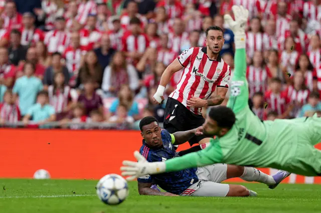 Athletic Bilbao's Spanish forward #07 Alex Berenguer (R) shoots past Arsenal's Brazilian defender #06 Gabriel (C) as Arsenal's Spanish goalkeeper #01 David Raya reaches for the ball