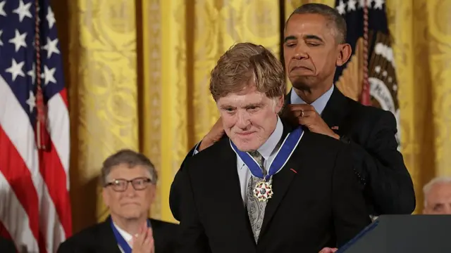 Robert Redford being awarded a medal by Barack Obama