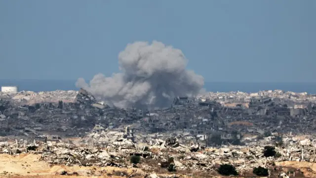 Smoke spreads over a derelict city