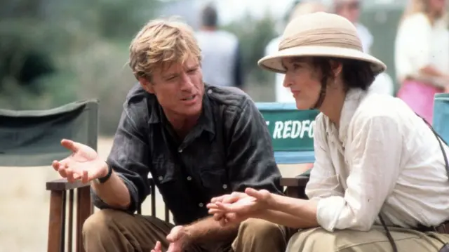 The two actors sit next to each other as Redford speaks to Streep