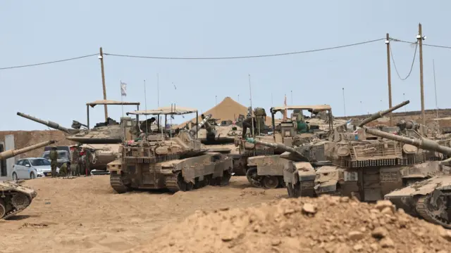 Israeli tanks and armoured vehicles are deployed along the Israel-Gaza border in southern Israel