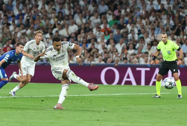 Real Madrid's French forward #10 Kylian Mbappe scores his team's first goal from the penalty spot