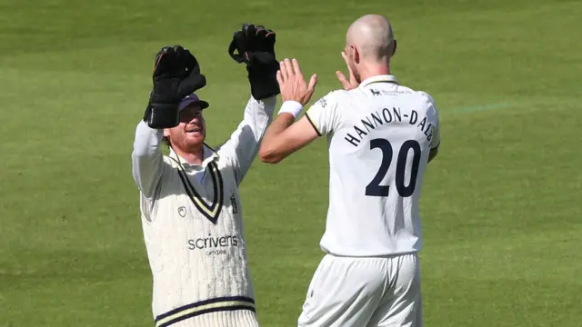 Alex Davies and Olly Hannon-Dalby celebrate a wicket for Warwickshire