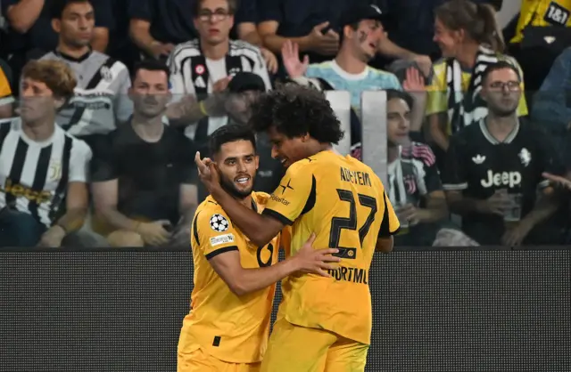Borussia Dortmund's Yan Couto celebrates scoring their third goal with Borussia Dortmund's Karim Adeyem