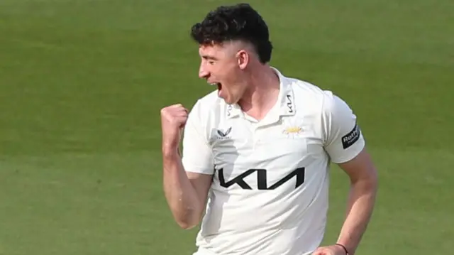 Surrey's Matt Fisher celebrating one of his five wickets against Warwickshire