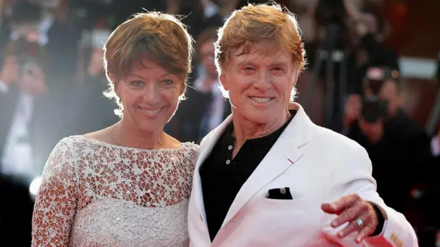 Director Robert Redford (R) and his wife Sibylle pose on the red carpet