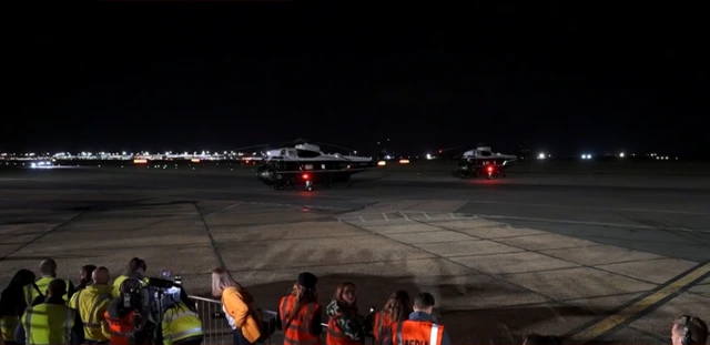 Reporters are seen on the tarmac