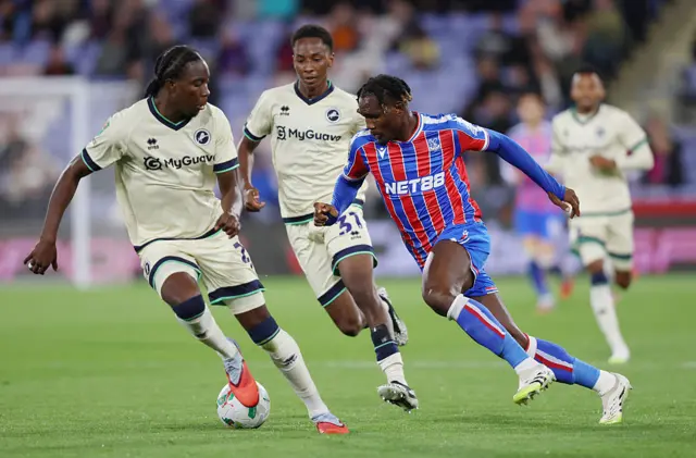 Chrisantus Uche of Crystal Palace runs for the ball ahead of Kamarl Grant of Millwall