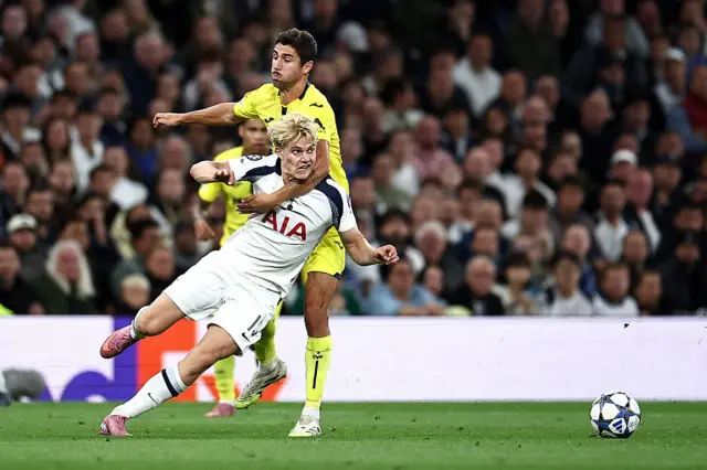 Tottenham Hotspur's Swedish midfielder #15 Lucas Bergvall is fouled by Villarreal's Spanish midfielder #14 Santi Comesana during the UEFA Champions League football league stage match between Tottenham Hotspur and Villarreal at the Tottenham Hotspur Stadium in London, on September 16, 2025.