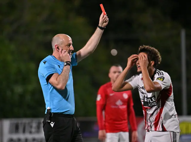 Declan Hassan shows a red card to Finlay THorndike