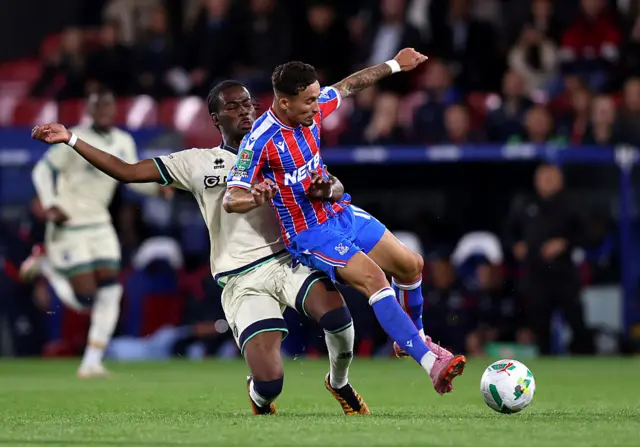 Yeremy Pino of Crystal Palace is tackled by Derek Mazou-Sacko of Millwall
