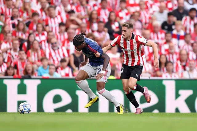 Noni Madueke of Arsenal is challenged by Robert Navarro of Athletic Club during the UEFA Champions League 2025/26 League Phase MD1 match between Athletic Club and Arsenal FC at Estadio de San Mames on September 16, 2025 in Bilbao, Spain.
