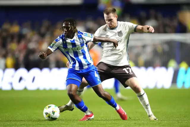 Sheffield Wednesday's Sean Fusire (left) and Grimsby's Cameron McJannett battle for the ball during the Carabao Cup third round match at Hillsborough, Sheffield.