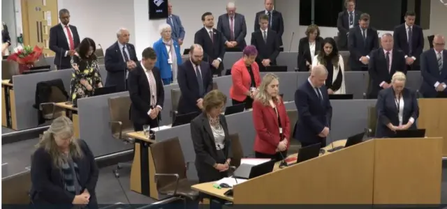 Senedd members observed a minute's silence