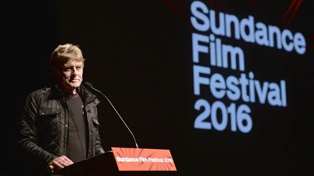 Redford speaking at a podium