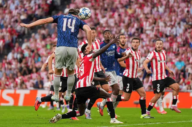 Arsenal's Swedish forward #14 Viktor Gyokeres heads the ball next to Athletic Bilbao's Ghanaian forward #09 Inaki Williams during the UEFA Champions League first round day 1 football match between Athletic Club Bilbao and Arsenal at the San Mames stadium in Bilbao on September 16, 2025.