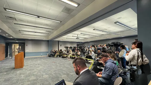 TV and print media awaits a press conference with the Utah County Attorney and other officials.