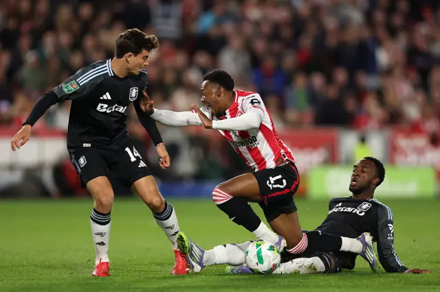 Antoni Milambo of Brentford is challenged by Pau Torres and Lamare Bogarde of Aston Villa