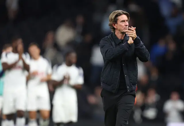 Tottenham Hotspur manager Thomas Frank applauds the fans