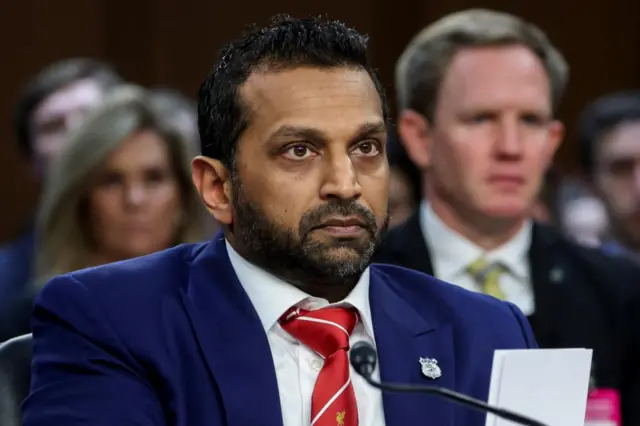 Kash Patel, not for the first time, is wearing a Liverpool Football Club tie