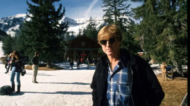Robert Redford poses in a picture taken in 1994 next to mountains.
