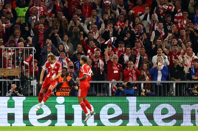 Harry Kane of Bayern Munich celebrates scoring his team's third goal with teammate Luis Diaz during the UEFA Champions League 2025/26 League Phase MD1 match between FC Bayern München and Chelsea FC at Football Arena Munich on September 17, 2025 in Munich, Germany.