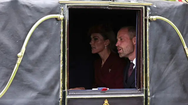 Britain's Prince William, Prince of Wales and Britain's Catherine, Princess of Wales, travel in the Semi-State Landau during a horse-drawn procession towards Windsor Castle, at the start of a second State Visit for US President Donald Trump