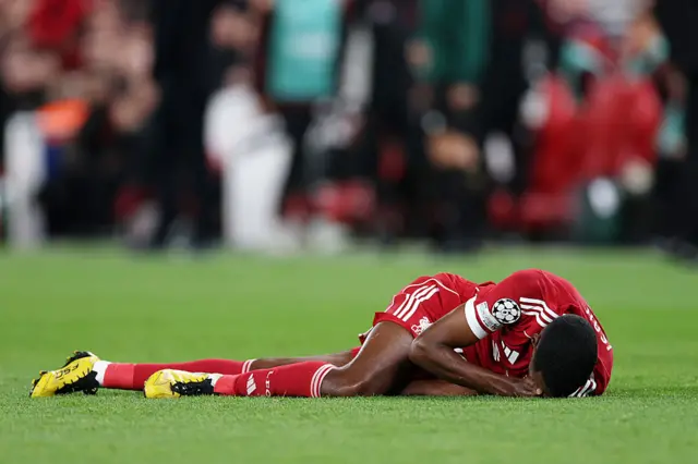 Alexander Isak of Liverpool reacts after going down during the UEFA Champions League 2025/26 League Phase MD1 match between Liverpool FC and Atletico de Madrid at Anfield on September 17, 2025 in Liverpool, England.