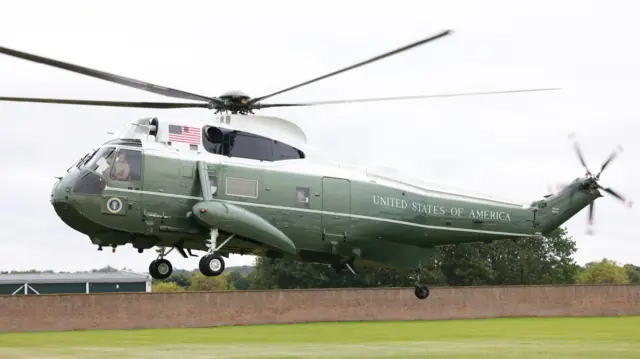 Marine One helicopter lands on the back lawn of Windsor Castle on a drizzly day