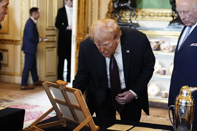 Donald Trump examines a painting