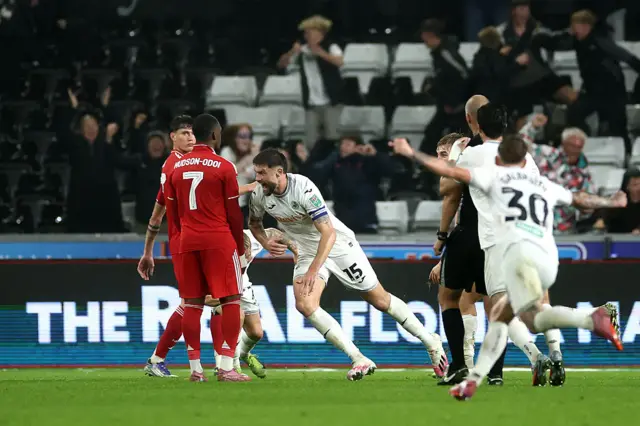 Swansea City captain Cameron Burgess celebrates