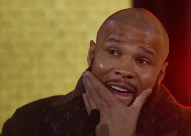 Chris Eubank Jr strokes his beard at a news conference