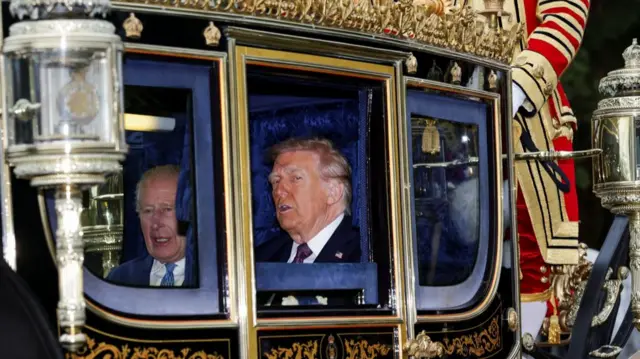 Britain's King Charles and U.S. President Donald Trump sit in a carriage during a procession through Windsor Castl