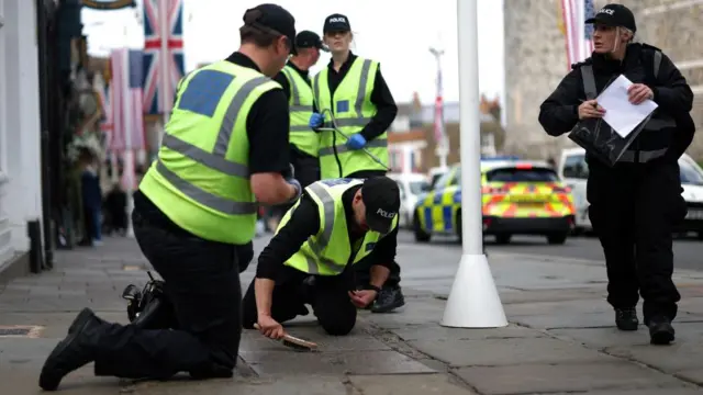 Police officers seen carrying out security checks in Windsor on Monday ahead of Trump's visit
