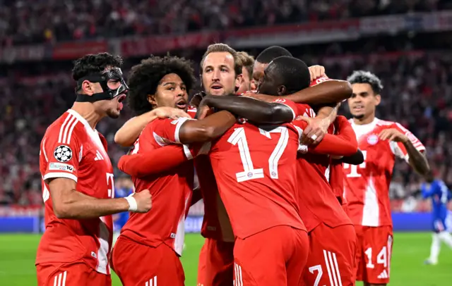 Bayern Munich's Harry Kane and teammates celebrate their first goal an own goal scored by Chelsea's Trevoh Chalobah