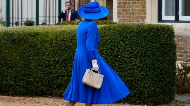 Queen Camilla wears a blue dress