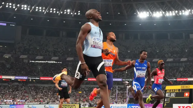 Botswana's Letsile Tebogo crosses the finish line to win heat 6 ahead of Netherlands' Xavi Mo-Ajok