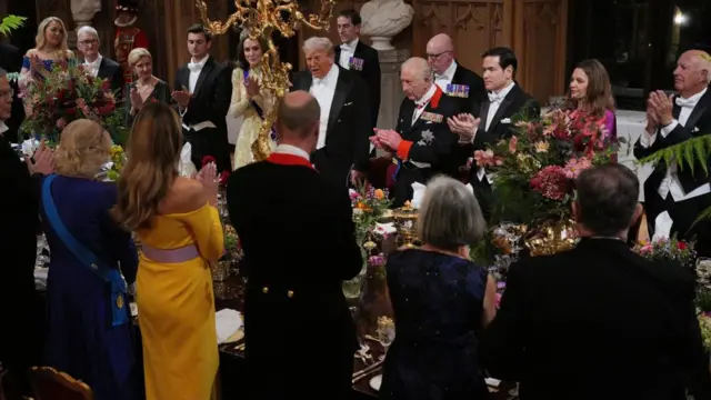 Dinner guests applaud after speeches