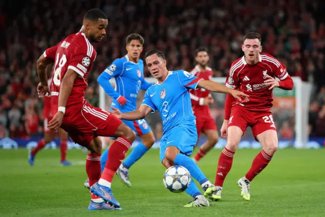Atletico Madrid's Giacomo Raspadori in action with Liverpool's Cody Gakpo
