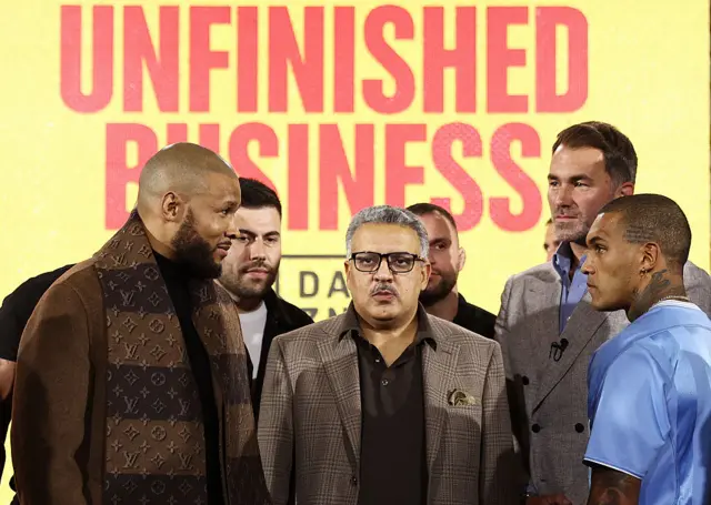 Chris Eubank Jr smirks at Conor Benn during a face-off