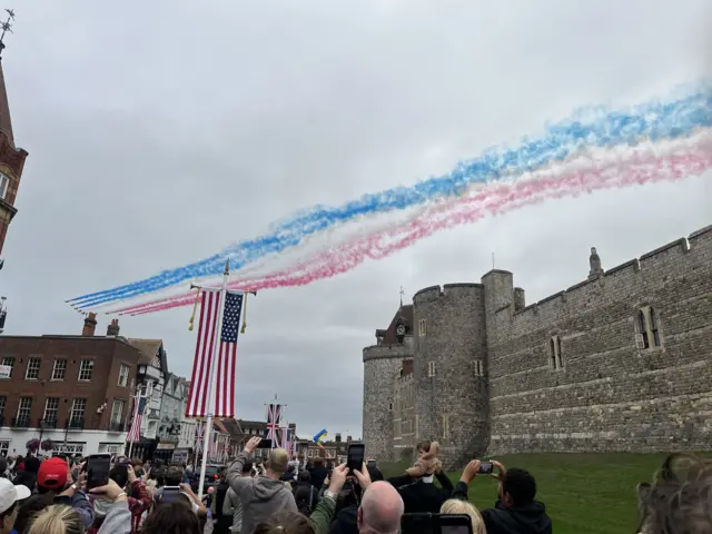 Red Arrows flypast over Windsor Castle seen from the road outside
